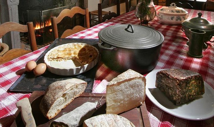 A large dining table for 10, in front of the fireplace